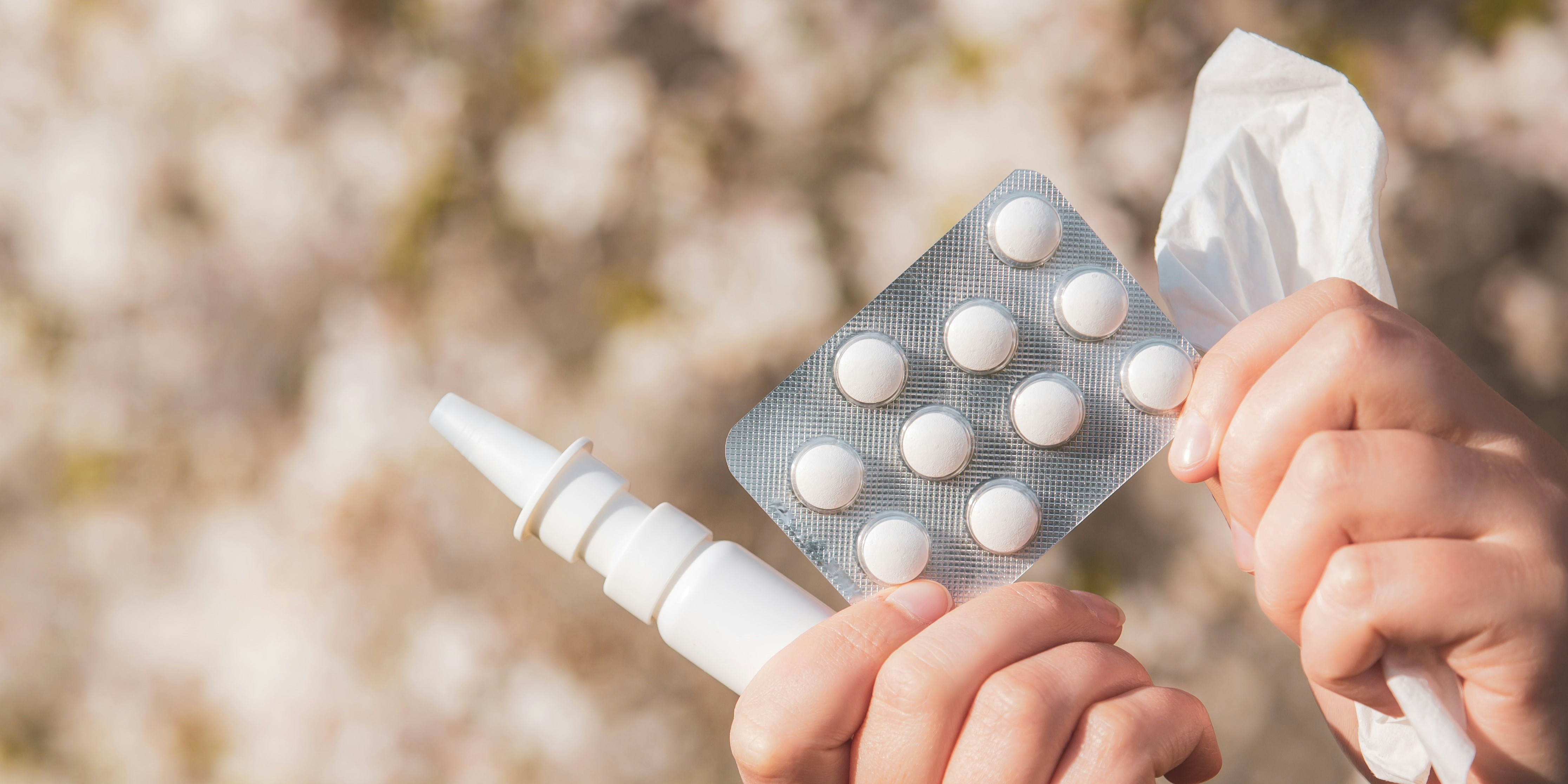 nasal spray, antihistamines and tissue in hand