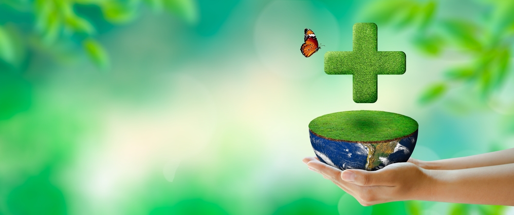 green pharmacy cross floating above earth
